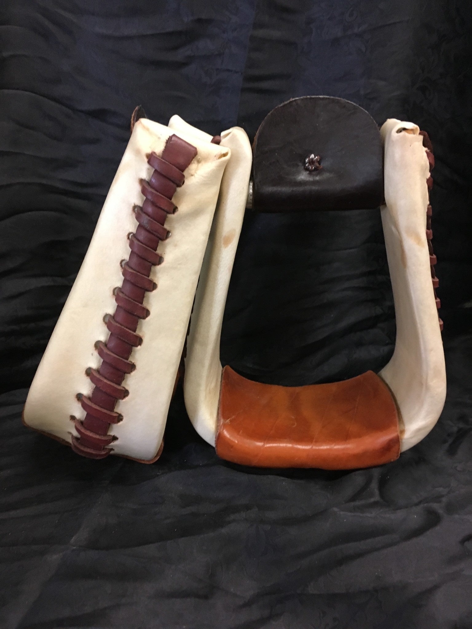 Deep Rawhide Covered Roper Stirrups.